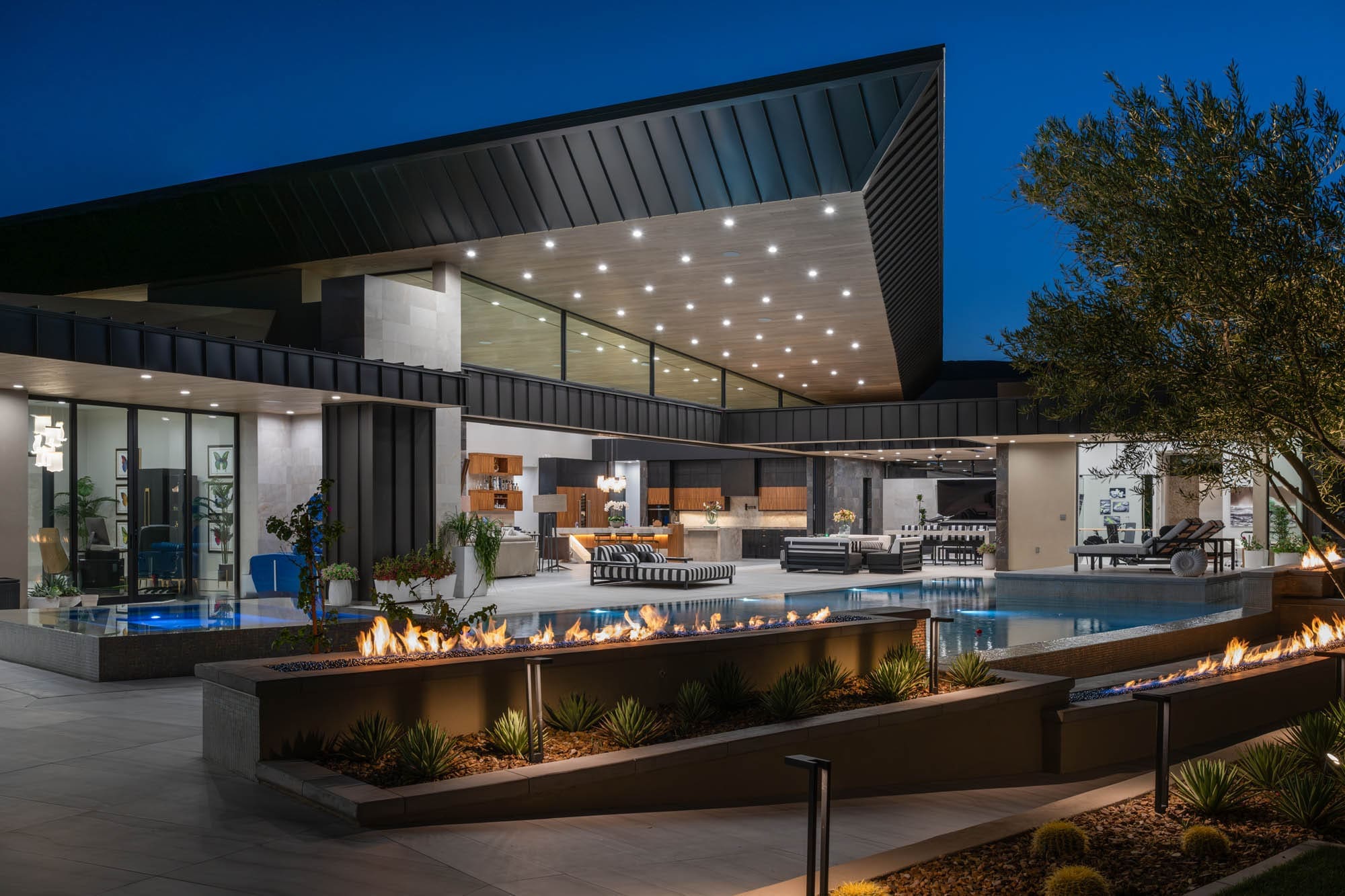 Luxury custom home in The Ridges Summerlin featuring modern architecture, expansive outdoor living spaces, fire features, and a resort-style pool.