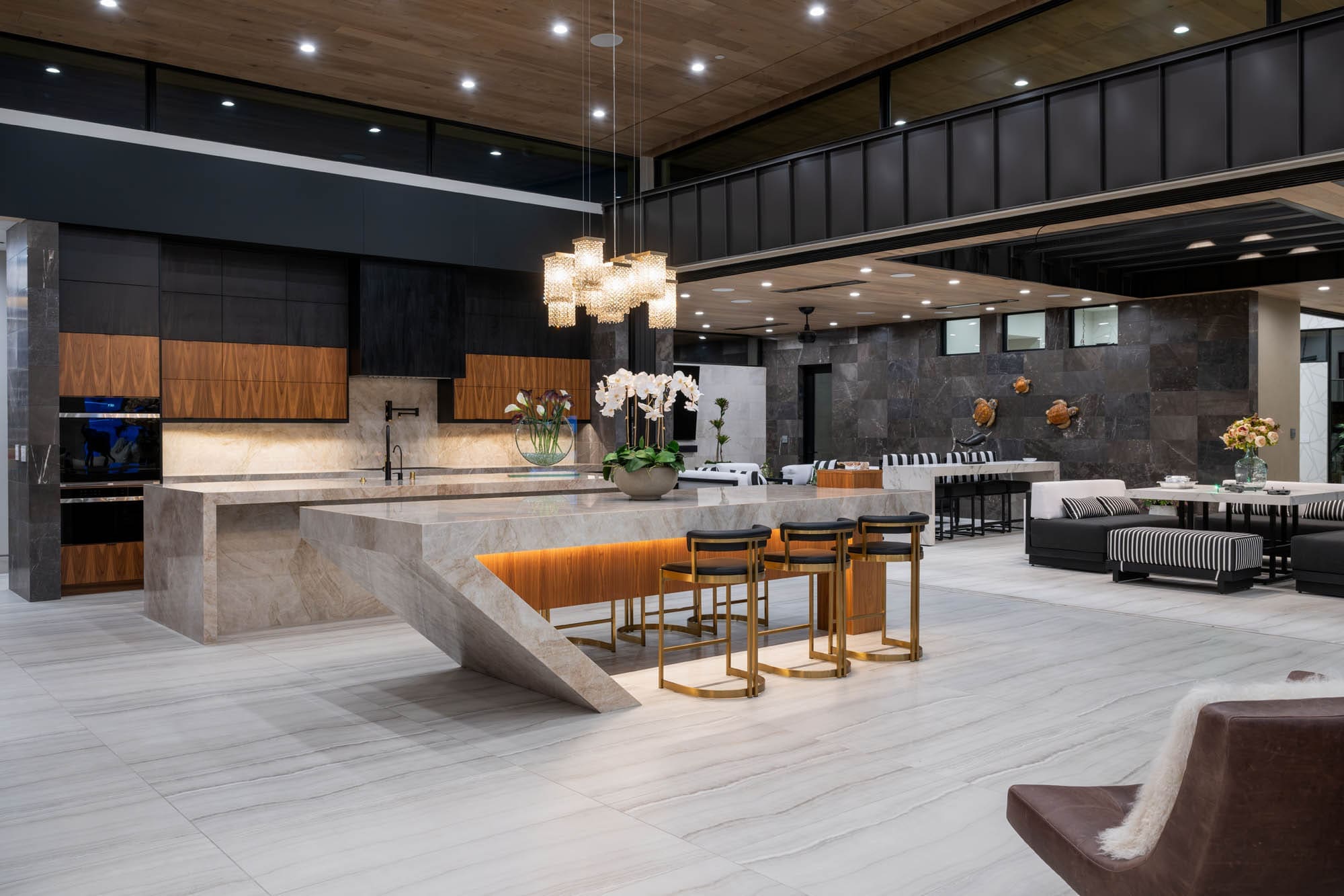 Luxury custom home kitchen and great room featuring a waterfall island, custom cabinetry, high ceilings, and premium finishes in a Las Vegas custom home.